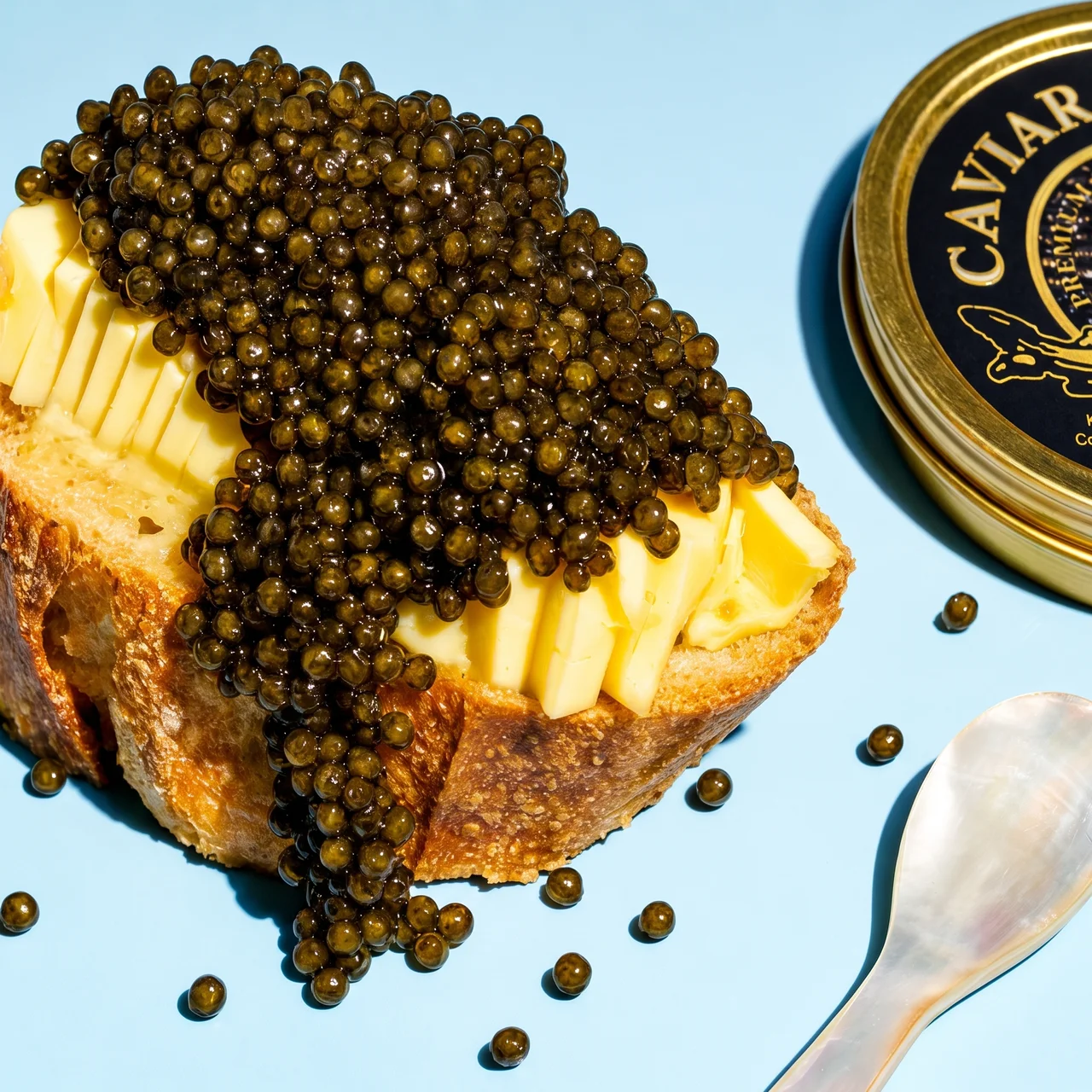 Kaluga Queen amber caviar heaped on crusty baguette with cold butter and a mother-of-pearl spoon